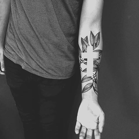 Freehand negative space cross & sunflower tattoo